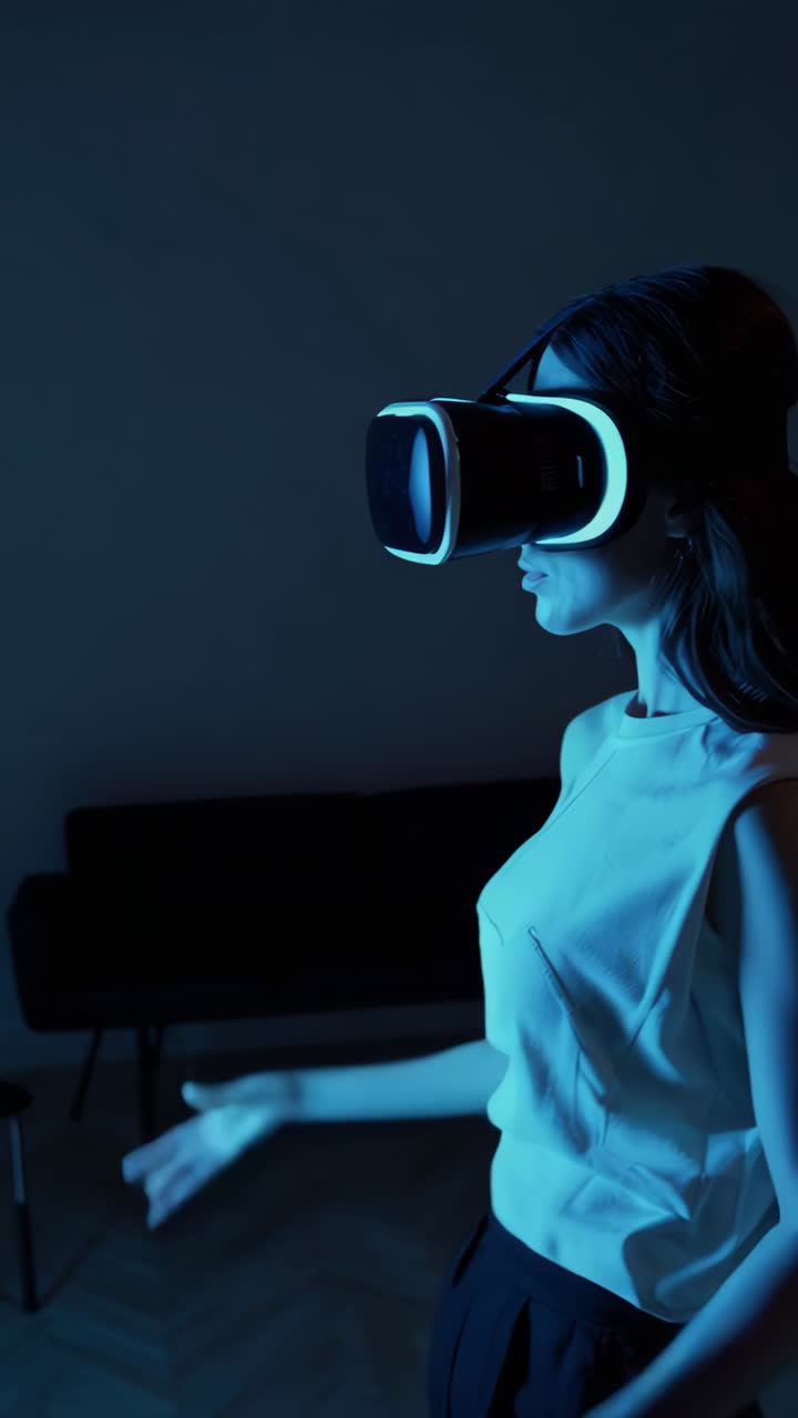 Woman Exploring Virtual Reality with VR Headset in a Dark Room