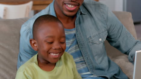 Father-and-son-using-technology-together