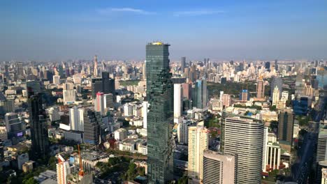 drone shot of mahanakhon tower in bangkok, silom area, business district, downtown