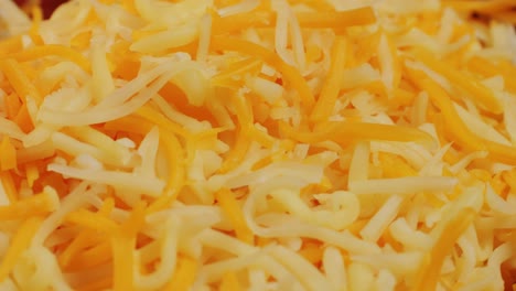 some different sorts of grate cheese on plate close up macro. chef grating cheese mozzarella, cheddar for meals. itallian food, pizza, pasta. high quality 4k footage
