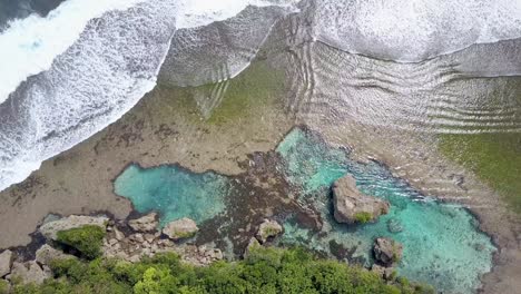 aerial view of ocean waves at rock pool magpupungko in siargao, the philippines