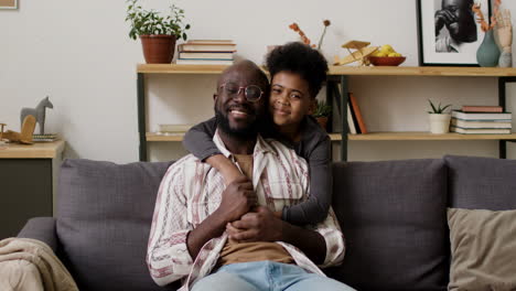 Father-and-son-hugging-in-the-living-room