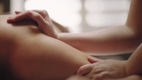 masseuse-is-massaging-arm-and-back-of-male-patient-in-chiropractic-clinic-closeup-view-professional-massage