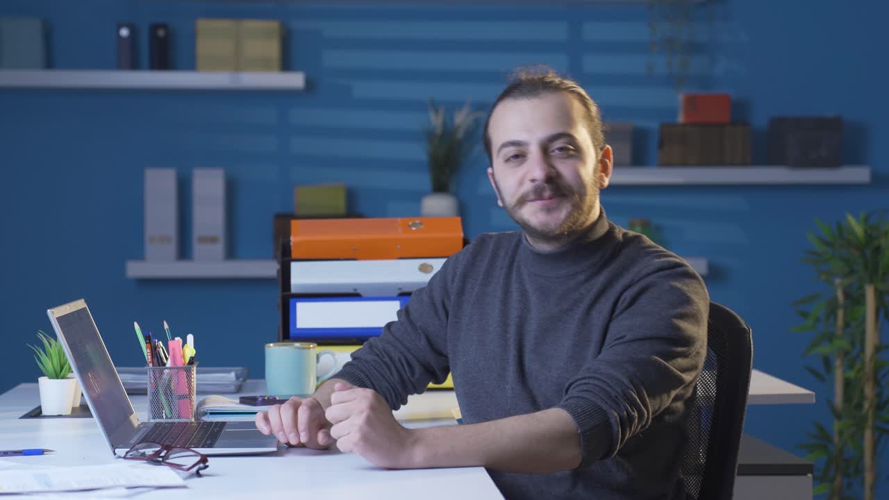 Uomo d'affari nel suo ufficio che ascolta attentamente la telecamera e accetta con positività