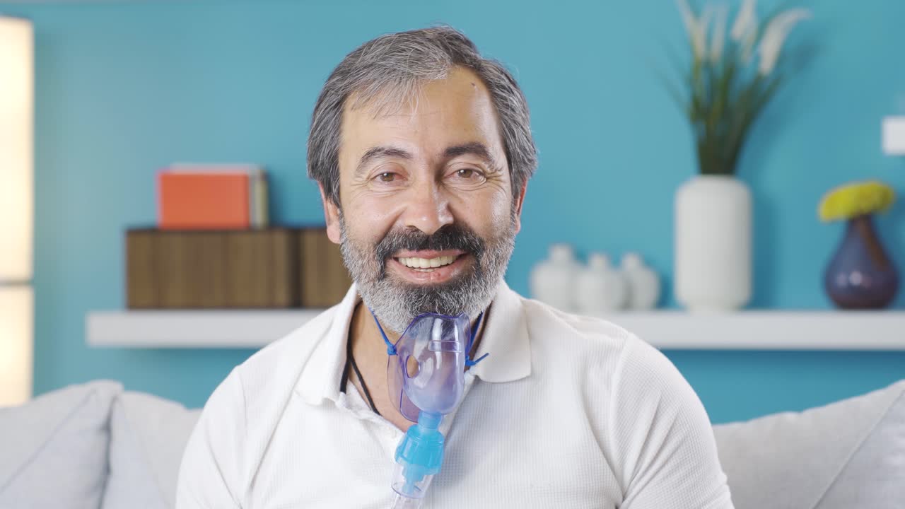 Man with COPD looking at camera and laughing.