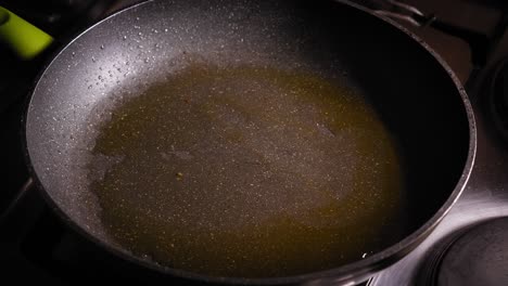 pour vegetable oil into pan then add chopped carrots and green bell pepper, stir and fry