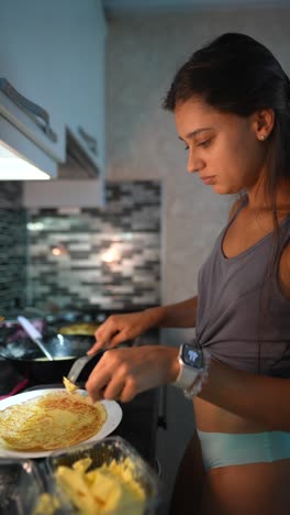 teenage girl making pancakes