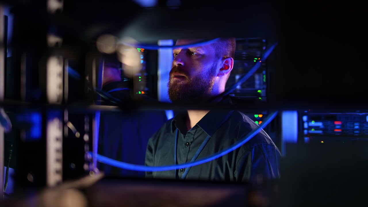 Man analysing data in a server room