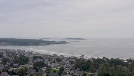 Drone-of-beach-community-with-small-Cessna-plane-taking-off-in-the-background-while-people-are-at-the-beach