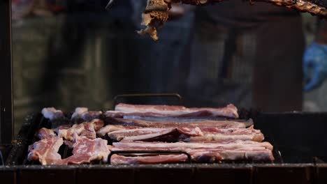 grill pork being seasoned with salt