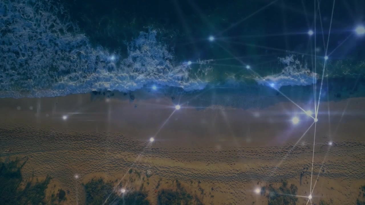 Aerial View of Ocean Waves Crashing on Beach with Digital Network Overlay