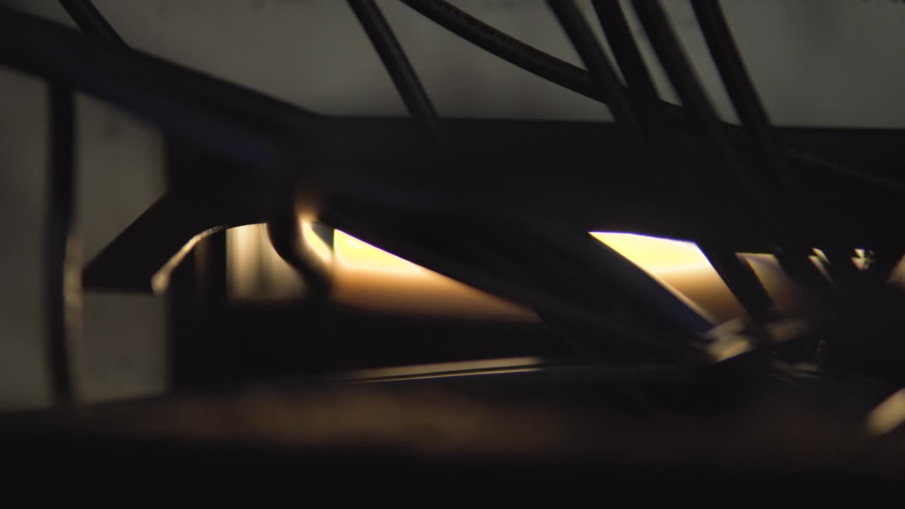 An SDI cable pushes through a small hatch, glowing in cinematic light. Perfect for broadcast, video production, studio setups, and connectivity visuals, capturing a high-tech, behind-the-scenes feel.