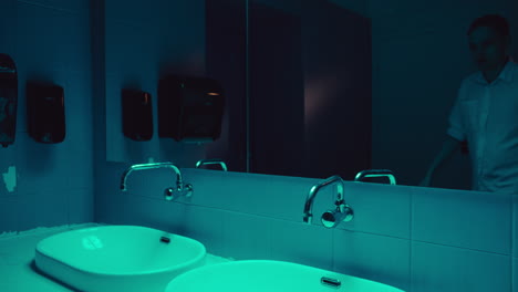 man looking in a bathroom mirror