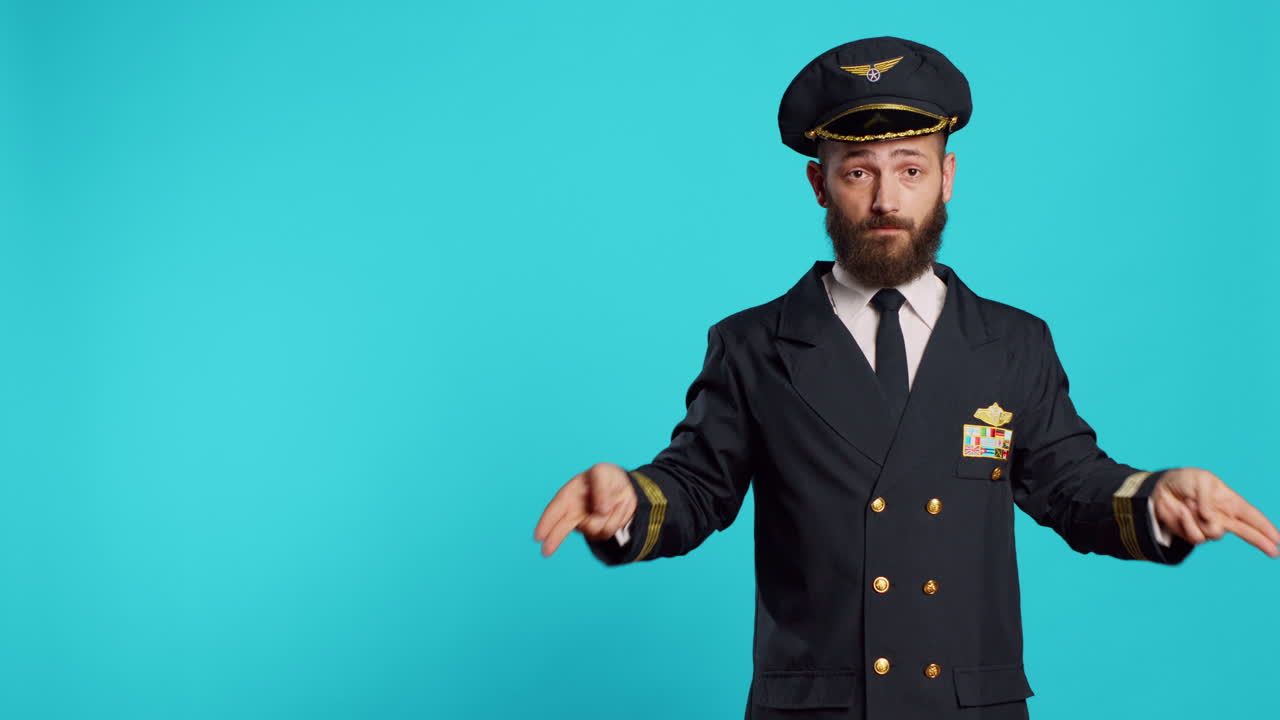 Caucasian male pilot doing landing signals for airplanes