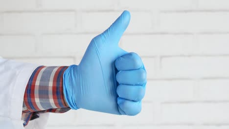 doctor giving thumbs up in blue gloves