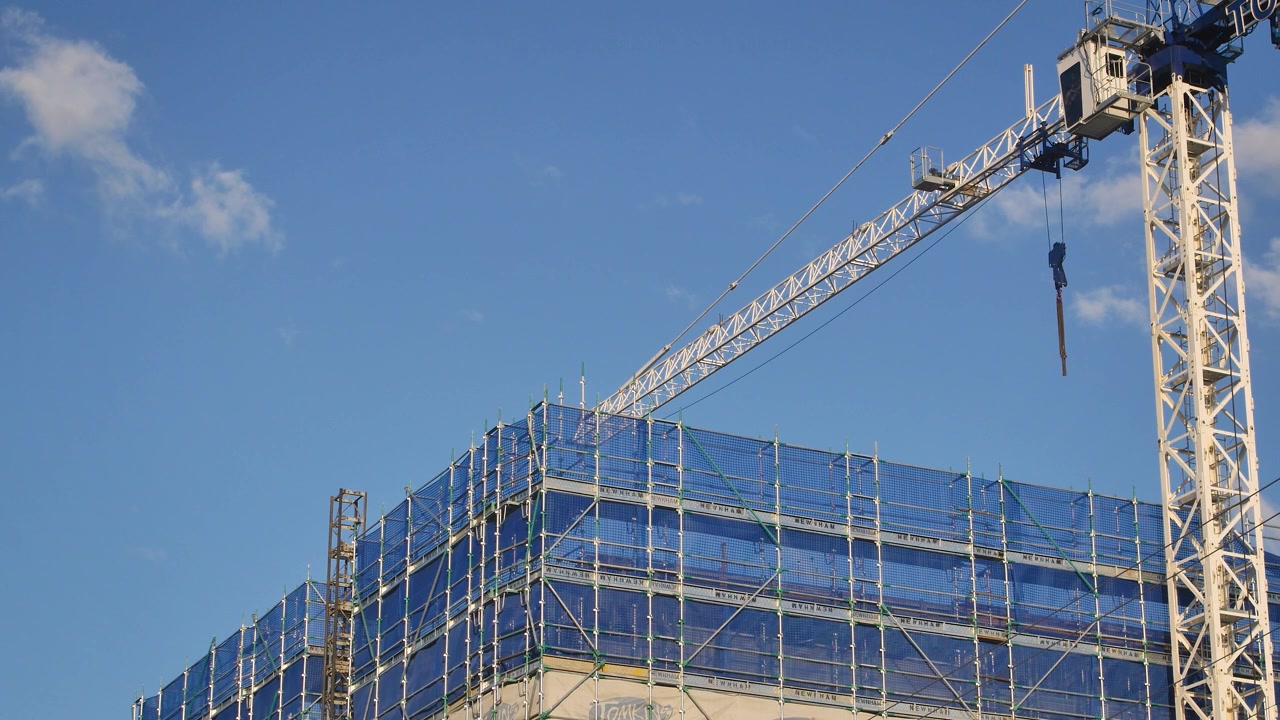 View of a crane on a construction site building units in Brisbane, Queensland, Australia.