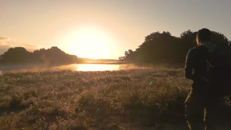 sunrise over a misty lake and forest