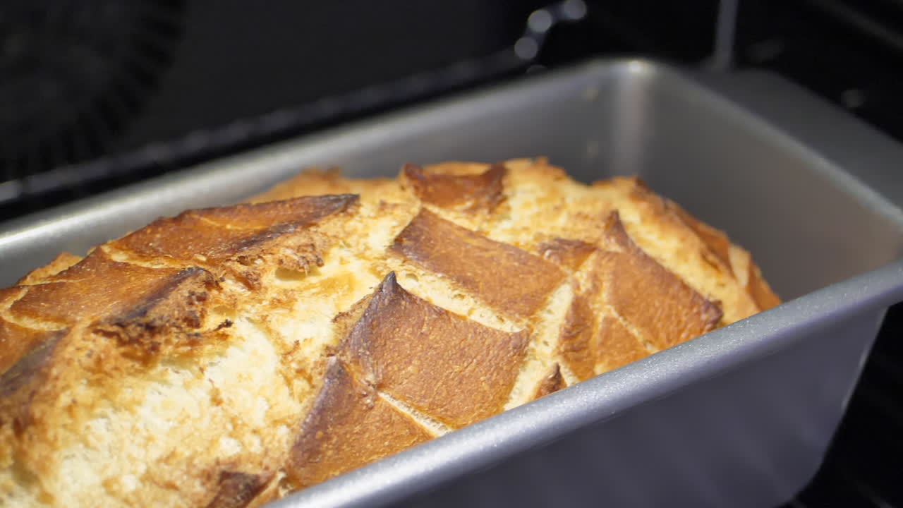 Close up shallow focus of a loaf of fresh bread baking in the oven