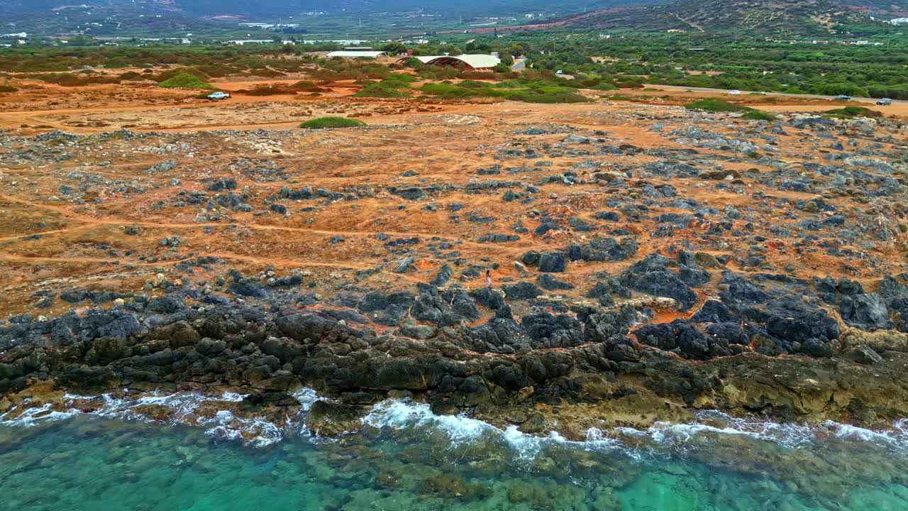 Woman looking out to sea along Potamos Beach