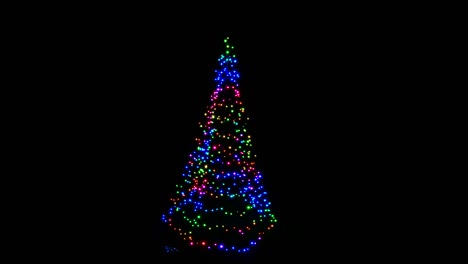 illuminated and colorful modern christmas tree on black background