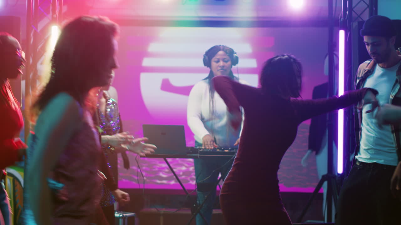 People Dancing and Enjoying Themselves at a Nightclub with a DJ