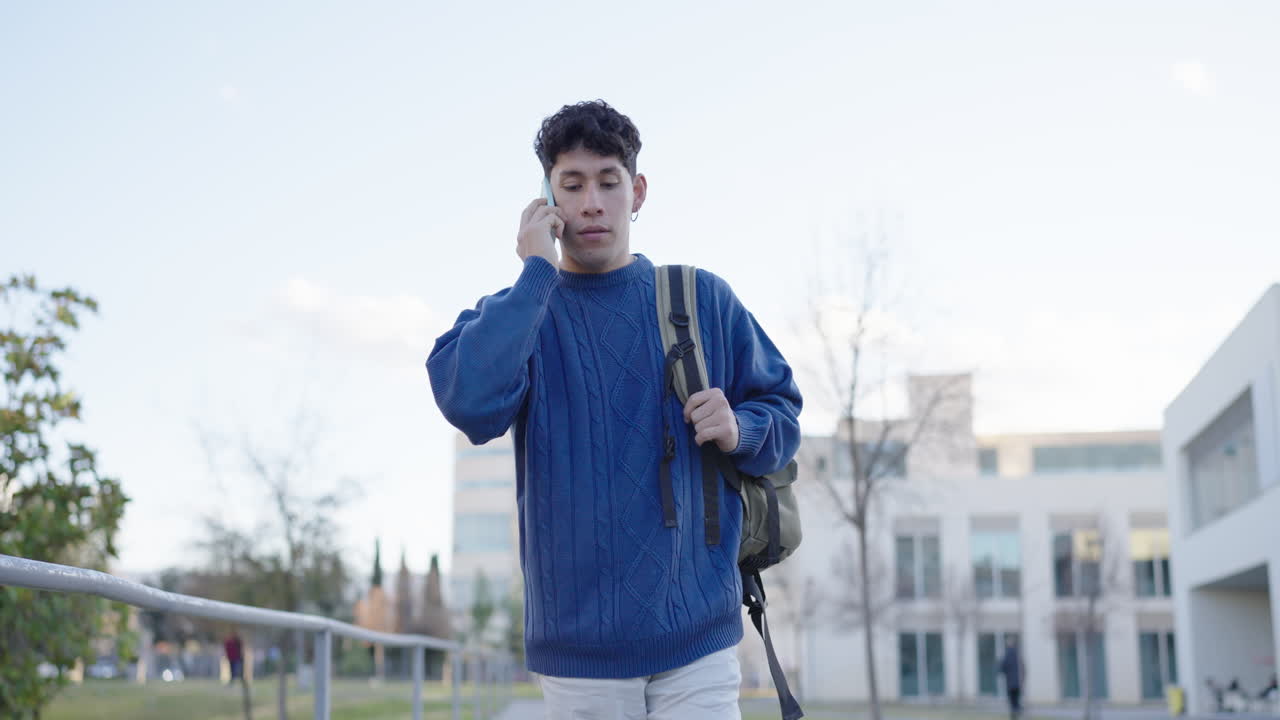 University student walking and talking on phone