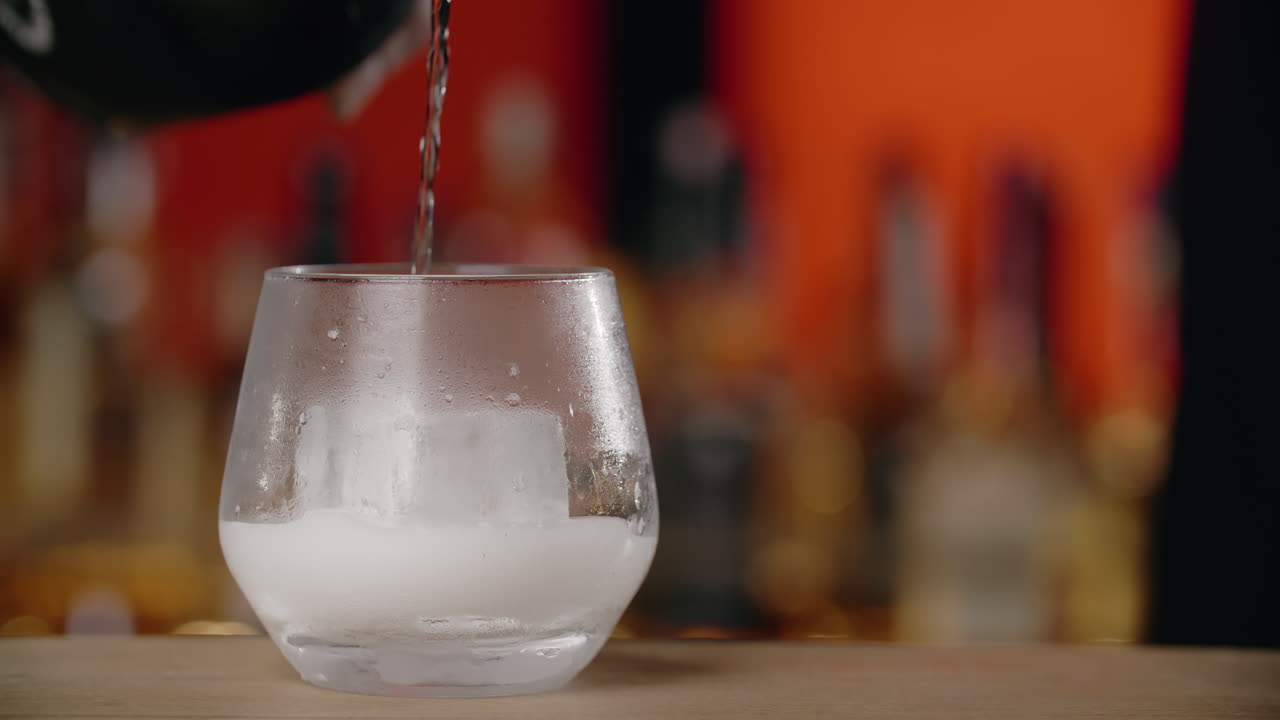 Pouring a Cocktail into a Glass with Ice