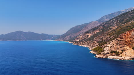 gorgeous coastal blue view. a breathtaking coastal landscape featuring clear blue water meeting rugged mountains under a bright sky