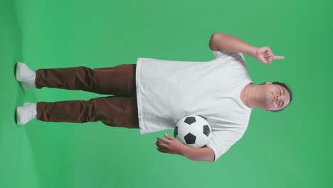man holding soccer ball and pointing
