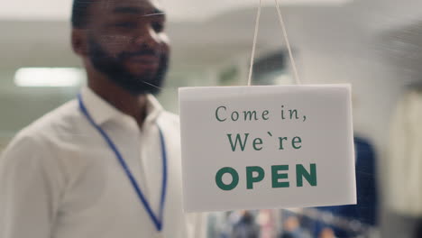 retail clerk opens clothing store