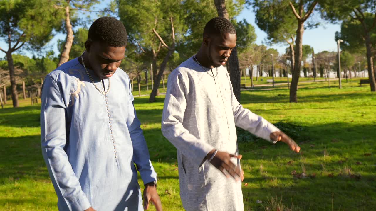 Two men praying in a park