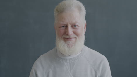 smiling elderly man giving an okay sign