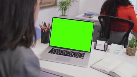 Biracial-businesswoman-using-laptop-for-video-call-with-copy-space