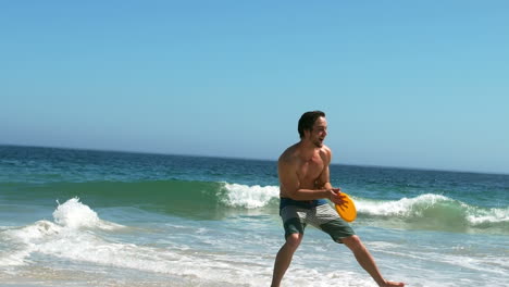 attractive man catching a frisbee