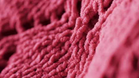 micro video of close up of pink wooly crochet fabric with copy space