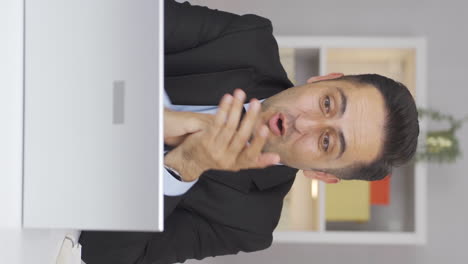 vertical video of home office worker man applauding what he sees on laptop.