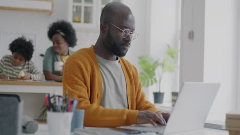 father working from home with children