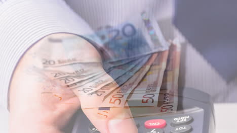 animation of dollar banknotes falling over hand of caucasian man holding payment terminal