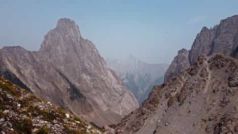 mountains paning with clear sky and rock rolling down