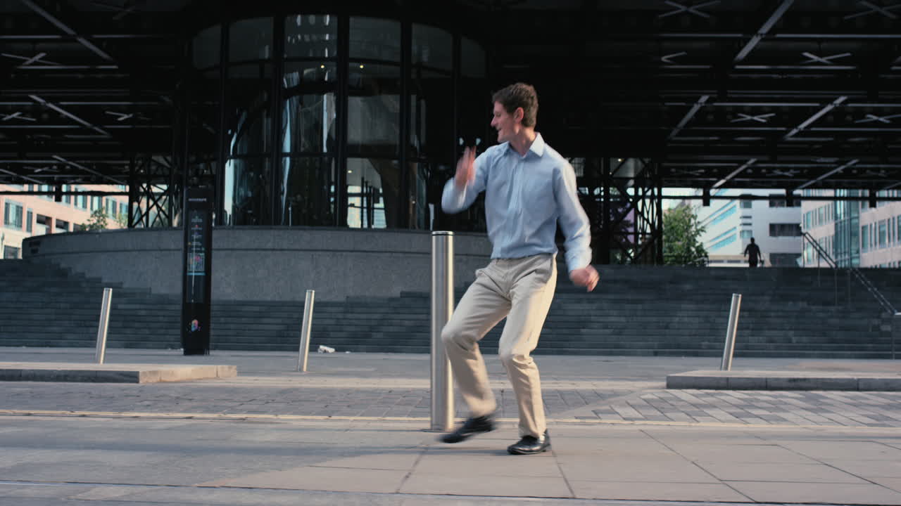 Contemporary funky caucasian businessman street dancer dancing freestyle in the city