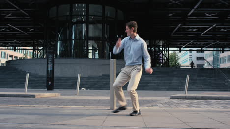 Contemporary-funky-caucasian-businessman-street-dancer-dancing-freestyle-in-the-city