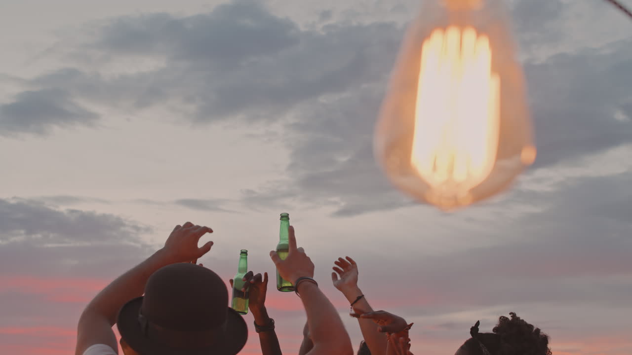 Hands of People Partying Outside in Evening