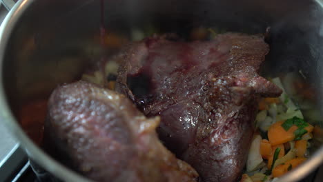 Vertiendo-Vino-Tinto-Sobre-Un-Jugoso-Trozo-De-Carne,-Chef-Hombre-Cocinando-Un-Estofado