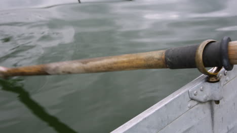 an oar rows a boat in slow motion