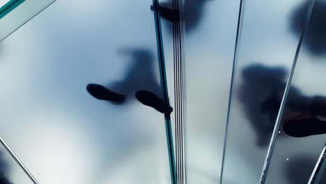 shadows and silhouettes on glass stairs