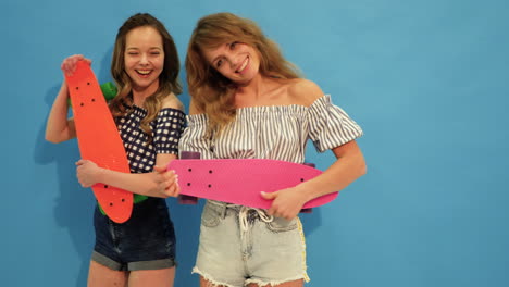 two girls with skateboards