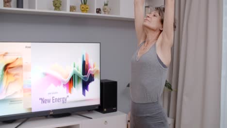 senior woman doing yoga at home