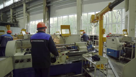 factory workers operating lathes