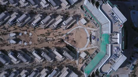 beach resort or residential development under construction from top down aerial view including main building, villas, swimming pool, beach and ocean on sunny day