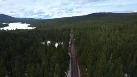 winter scene of cars traveling on oregon mountain pass highway